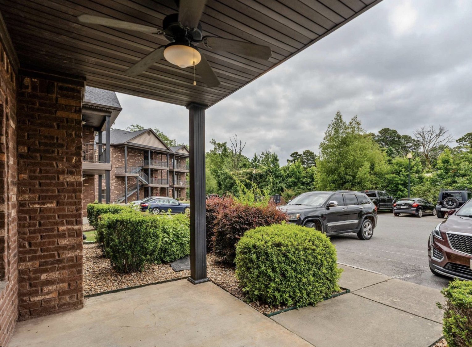 Covered patio overlooking the parking area and surrounding buildings