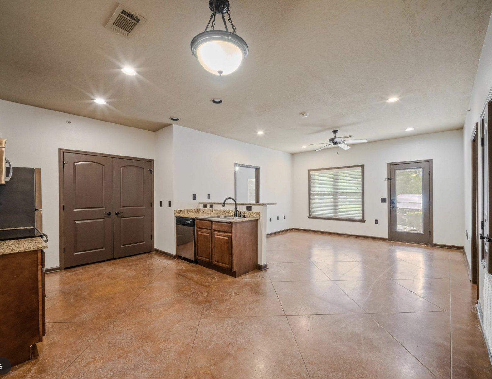 Open-concept kitchen and living area inside an existing apartment unit